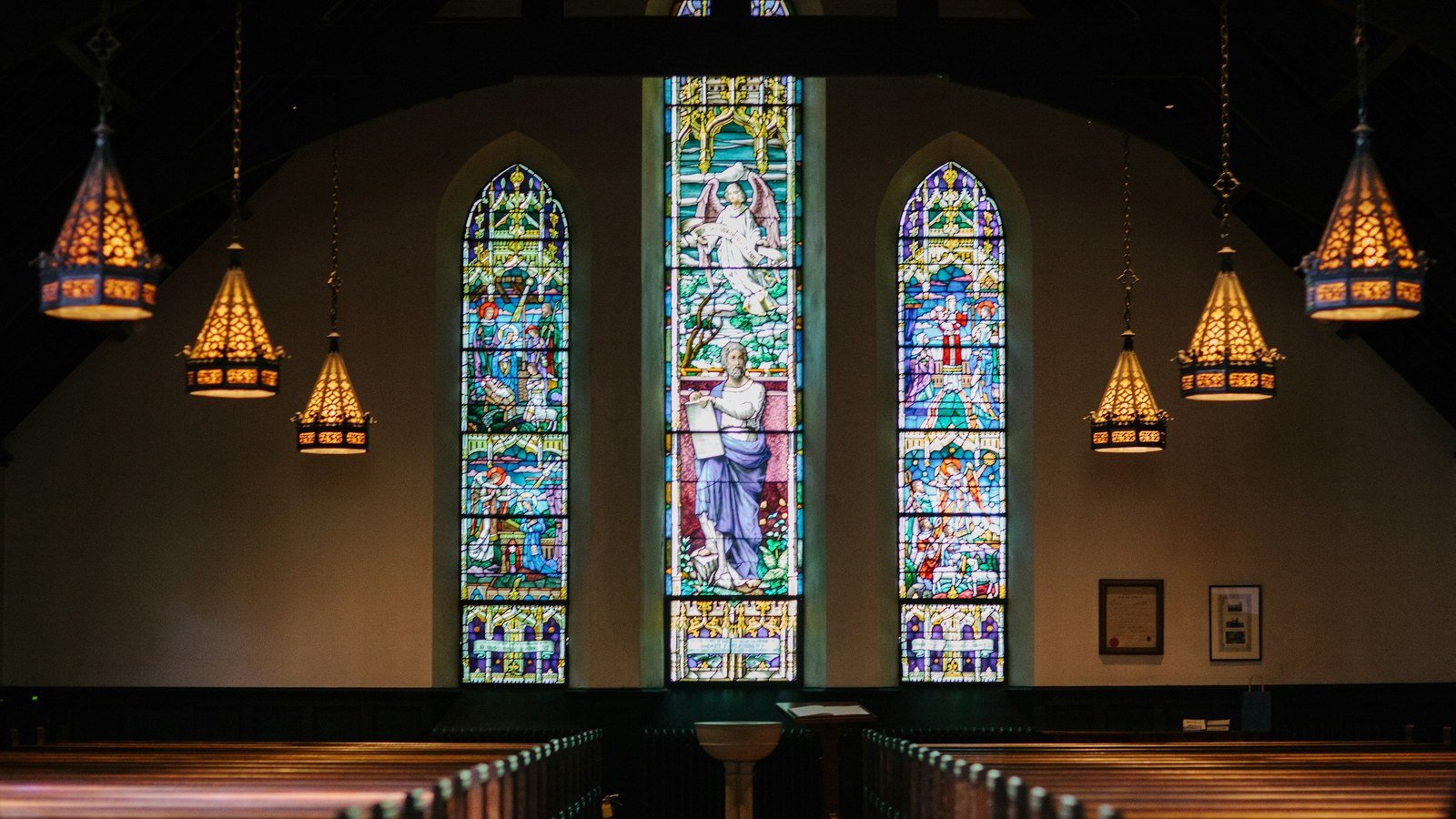 View from the back of a church sanctuary toward the altar — wall height follows the farthest seat